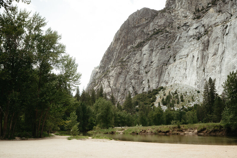 Large granite cliff over a small forest and river, great spot for a Yosemite elopement 