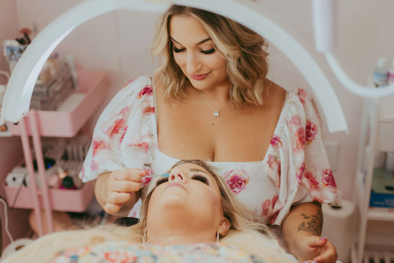 A lash technician working on a lash extension
