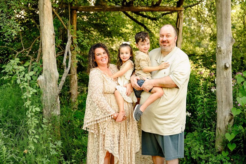 In a South Carolina Maternity session venue this family dressed in all natural tones stands together highlighting the mother's pregnant belly