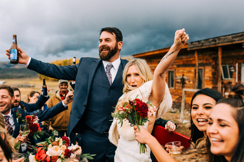 Photo of couple cheering after wedding ceremony