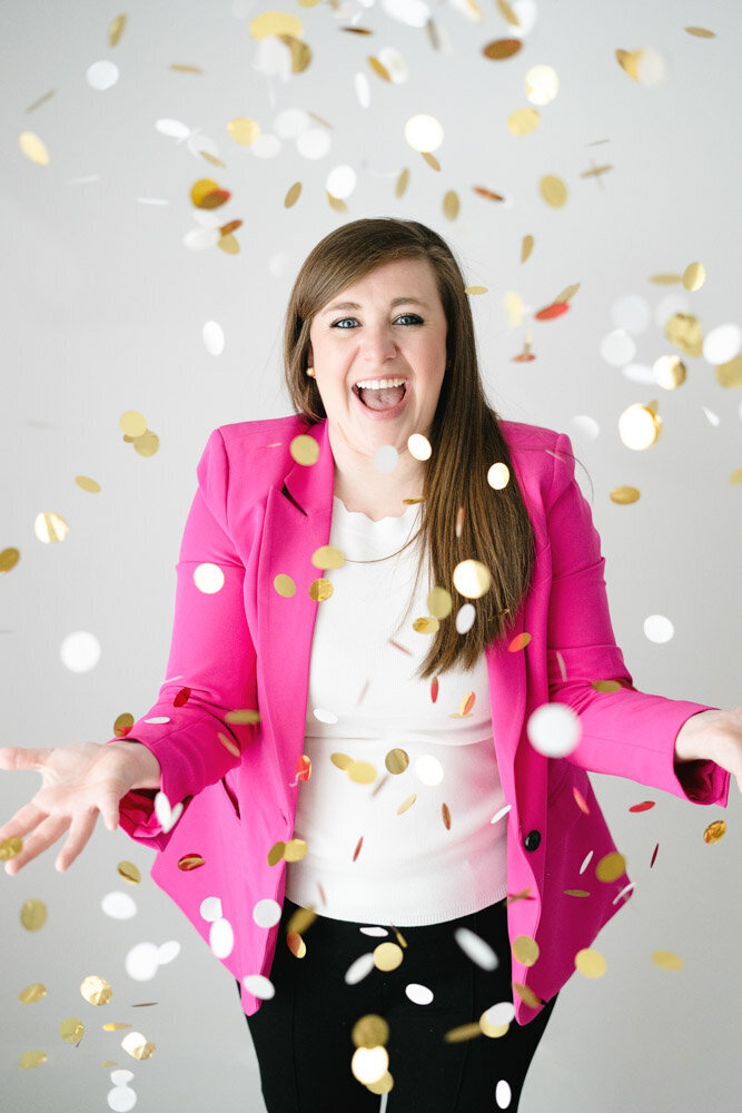 Pinks & Greens Travel Co. Founder Rachel Salley looks directly at camera and smiles while wearing a pink blazer and classic black Mickey Mouse ears.