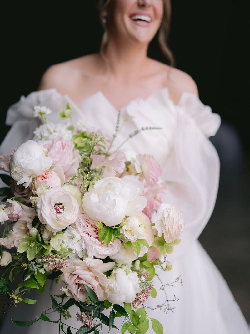 A traditional looking bride and groom laughing together