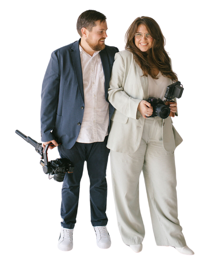 Tyler and Makenzie, a Jacksonville-based husband-and-wife wedding videography team, posing with their cameras, specializing in wedding and elopement films.