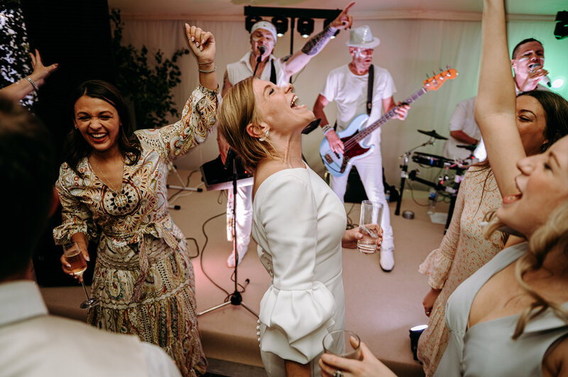 bride dancing having fun on the dance floor with her friends at the basin harbour in Vermont 