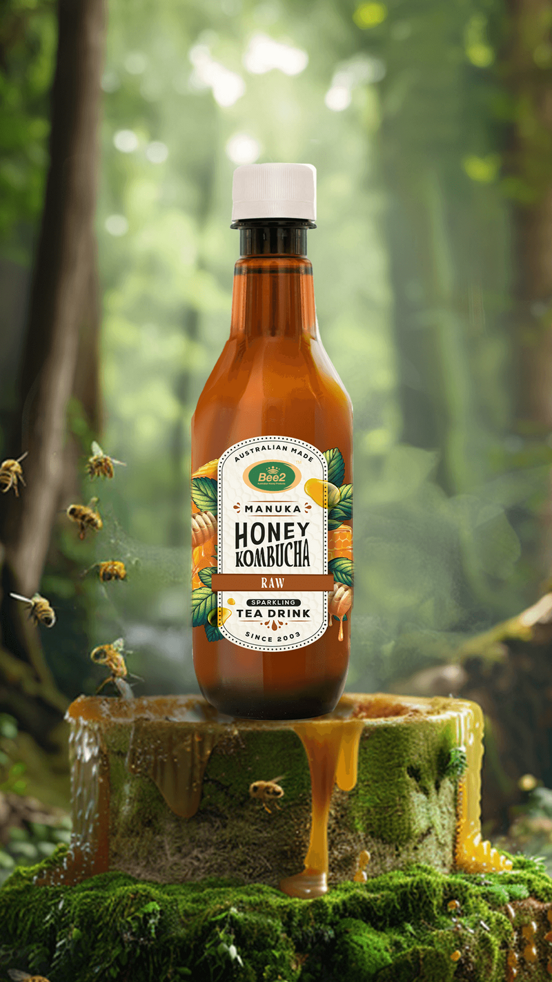 A bottle of Manuka Honey Kombucha is displayed in a forest setting, placed on a moss-covered stump with honey dripping down its sides. Bees are seen flying around the bottle, emphasizing the natural, raw ingredients of the drink. The green, leafy background and earthy tones highlight the kombucha’s organic and refreshing qualities, connecting it to nature.
