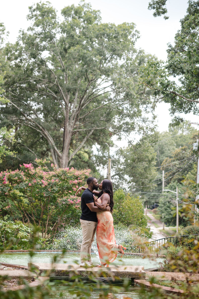 Romantic proposal kiss at Glencairn Gardens in Rock Hill, SC, captured by DeLong Photography, professional proposal photographer serving Charlotte and the Carolinas.
