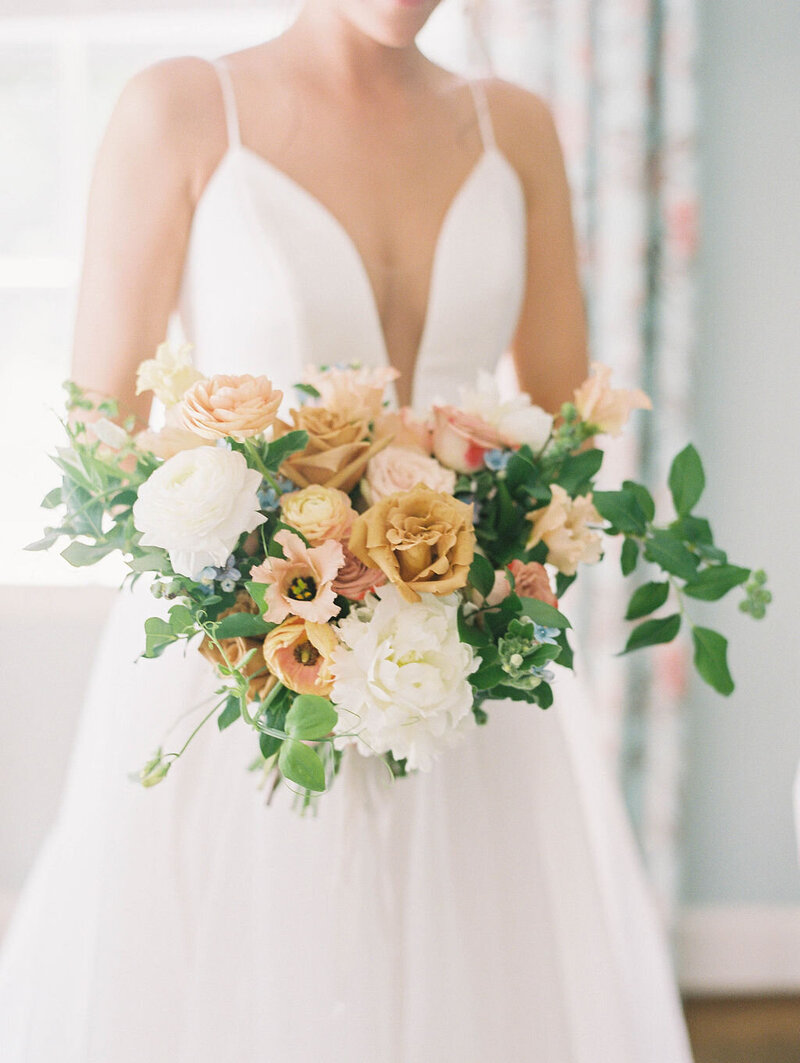 White, tan, blush flowers wedding bridal bouquet in roses, lisianthus, peonies and greens