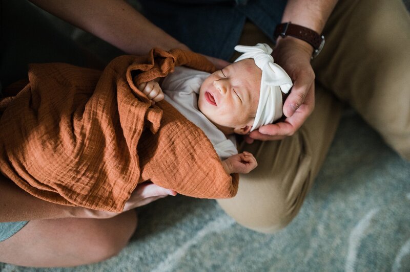 baby in mom and dad's hands in Pensacola Home