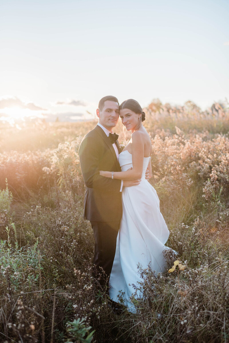 Ari and Justin hold each other in a field