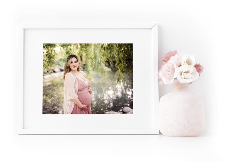Pregnancy photo shoot of expectant mom in soft pink flowing fabric.