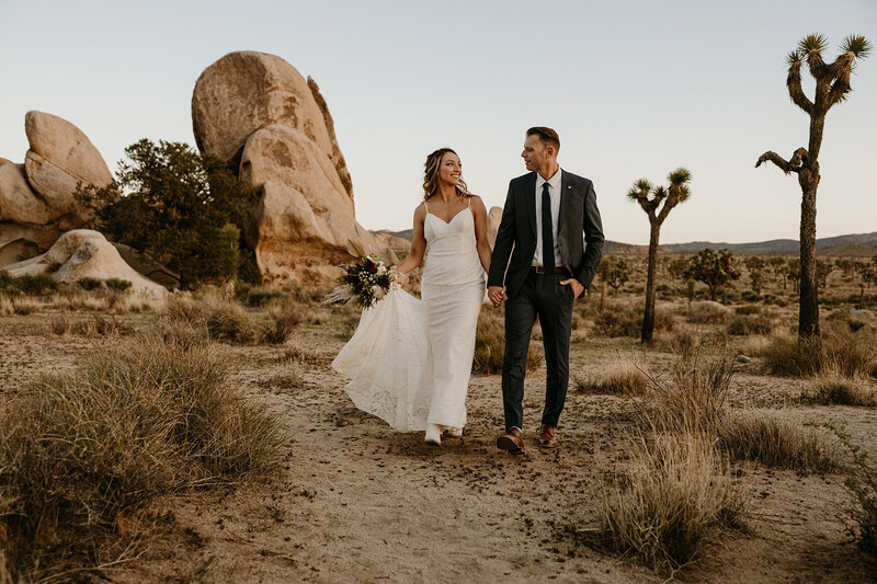 joshua tree elopement couple poses for photographer