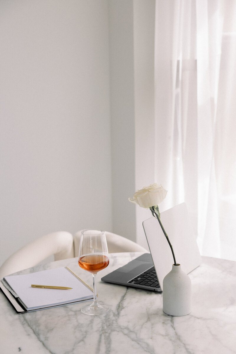 woman planning out her business goals on a calendar and notepad
