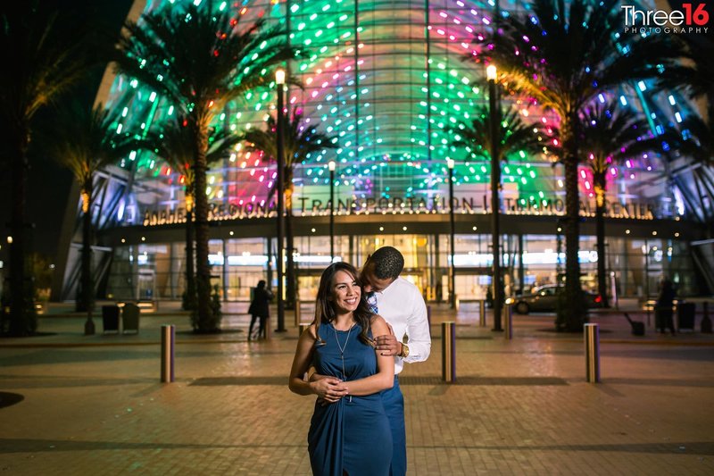 Engaged couple posing at the ARTIC Train Station in Anaheim