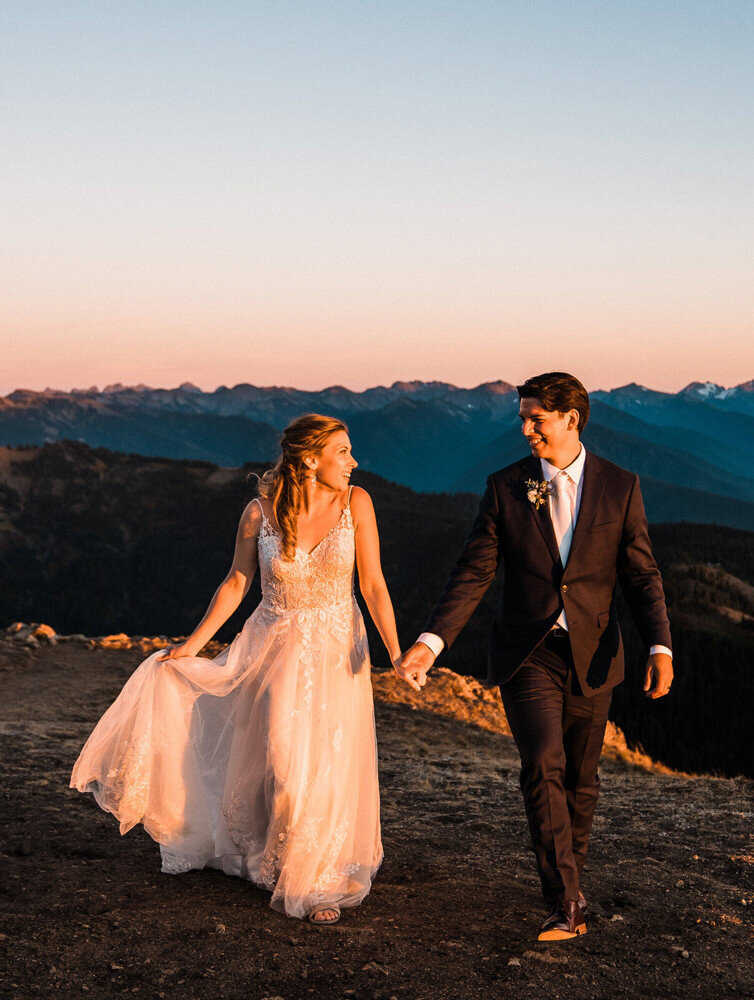 A bride and groom laugh together on a beach on Camano Island after their elopement