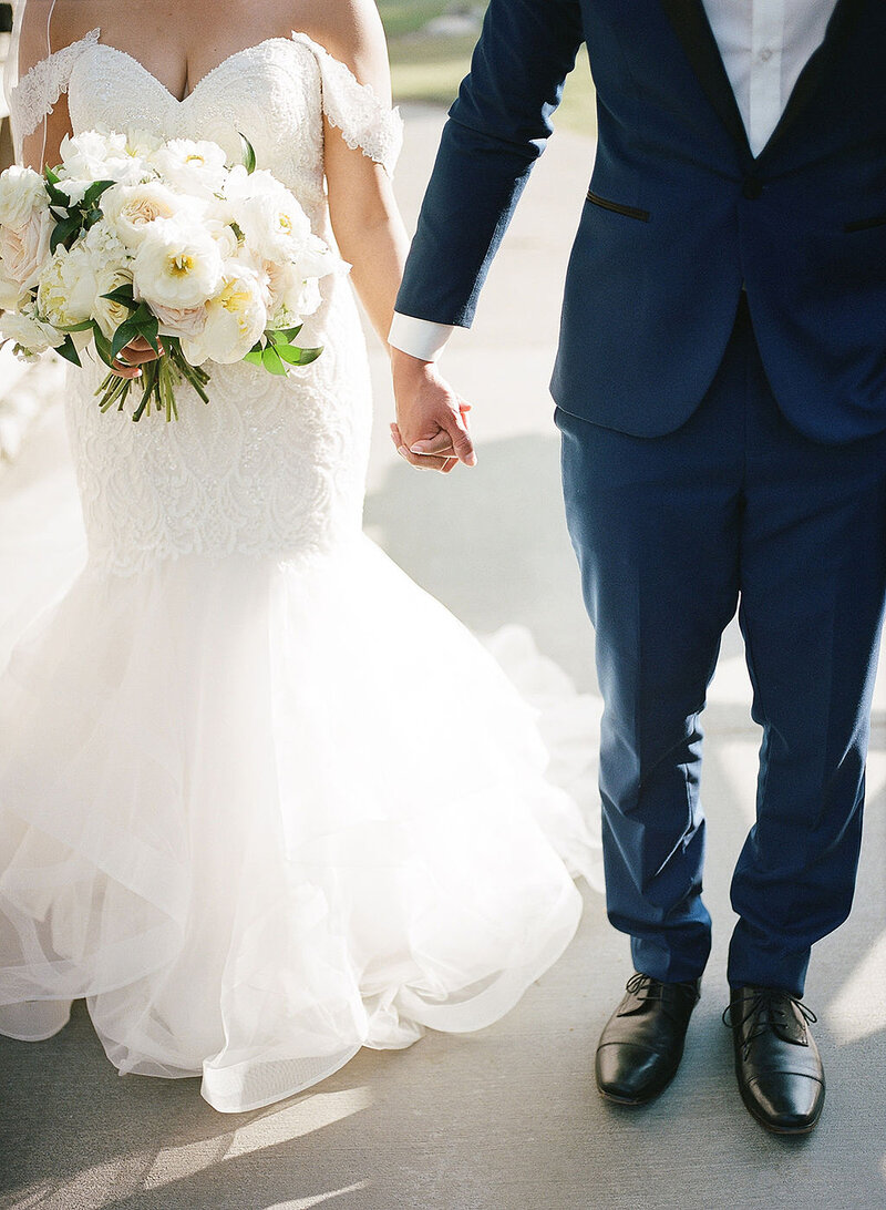 13-radiant-love-event-outdoor-closeup-of-bride-groom-holding-hands-full-body-no-heads-romantic-elegant-timeless
