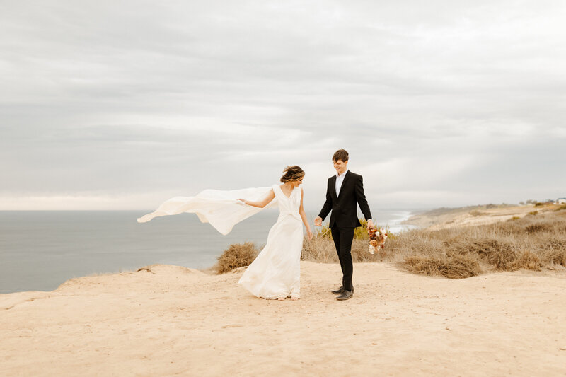 bride and groom at cliffside elopement in Laguna Beach