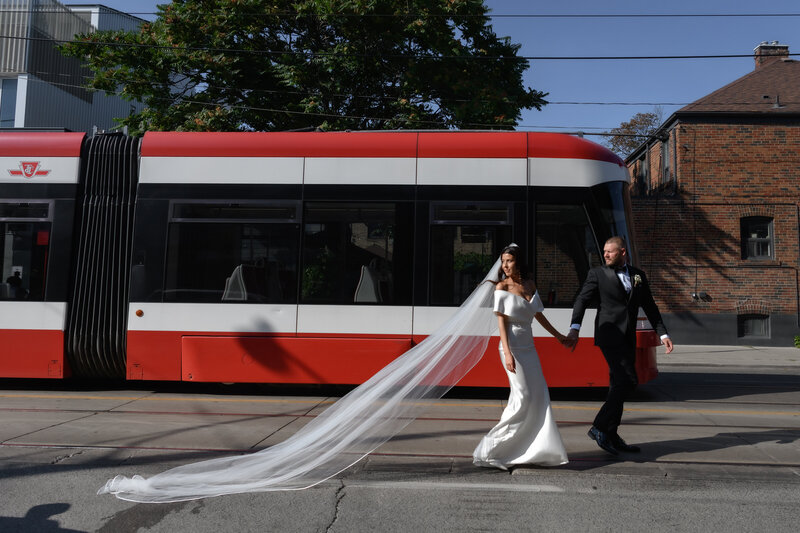 bride groom walking in Toronto in front of TTC bus