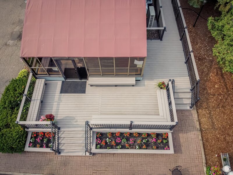 Aerial view of Adele's Frozen Custard showcasing the new TimberTech Advanced PVC deck with integrated benches on the perimeter of the deck, which maximizes seating area. 