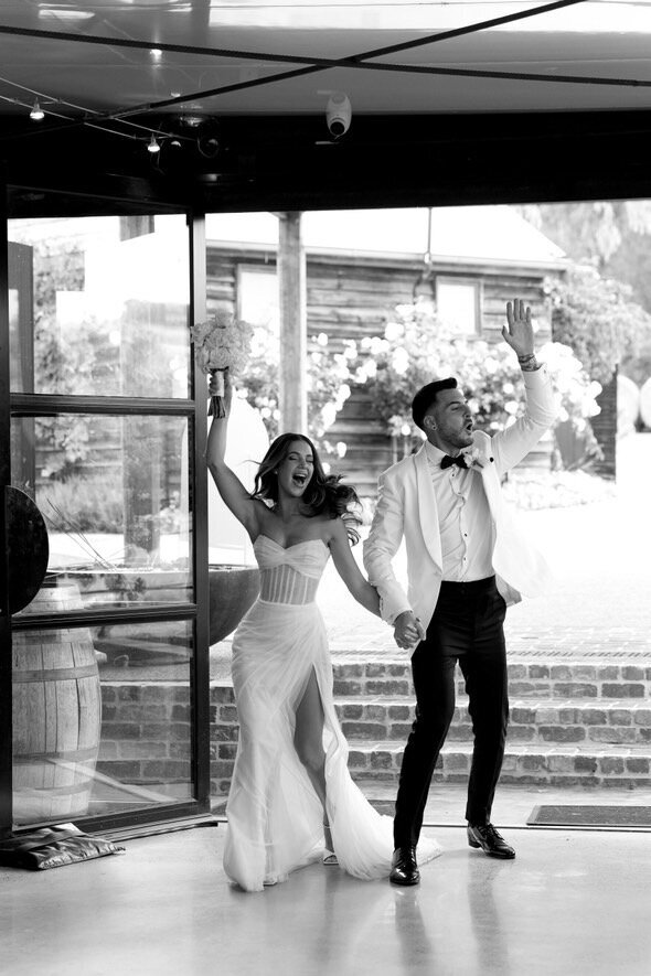 Couple celebrating their wedding entrance, exemplifying the joy and bespoke dance experiences offered by LIMCO.