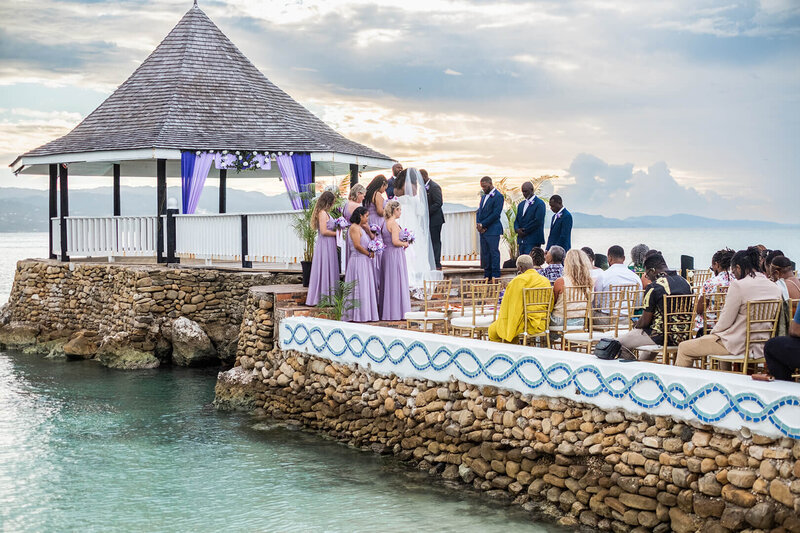 Bride and groom exchange vows during a waterfront destination wedding ceremony in Montego Bay, Jamaica.