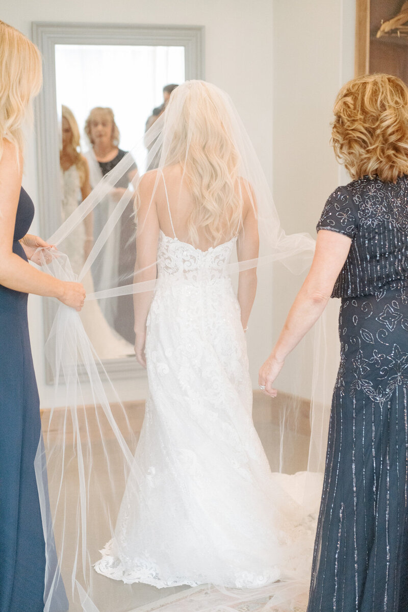 Bride getting ready in Canyonwood Ridge bridal suite with natural light and soft details