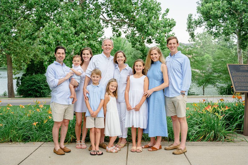 extended family portraits with everyone wearing blue and white