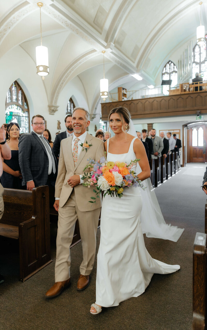 Michigan wedding day photography capturing emotional aisle moments for romantic couples seeking authentic storytelling imagery.