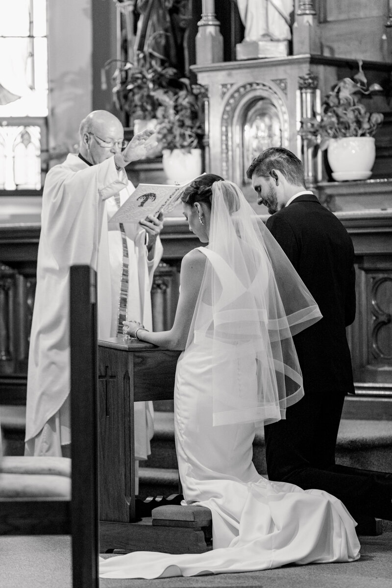 Bride and groom during their religious ceremony at the church on their wedding day