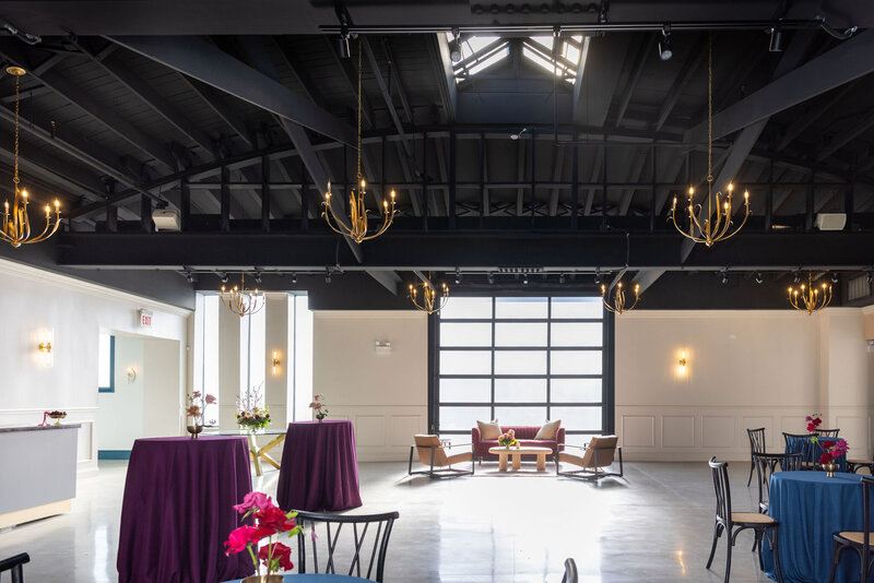 wide shot of Happy Hour space during daytime event, in house tables, lounge vignette, and natural light and added lighting details
