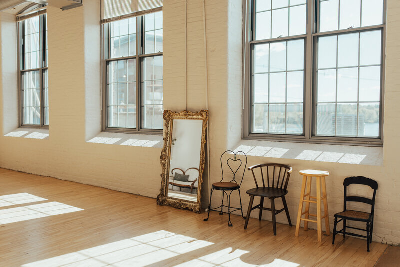 Large sunlit photography studio with beautiful mirror and chairs at The Archer Atelier