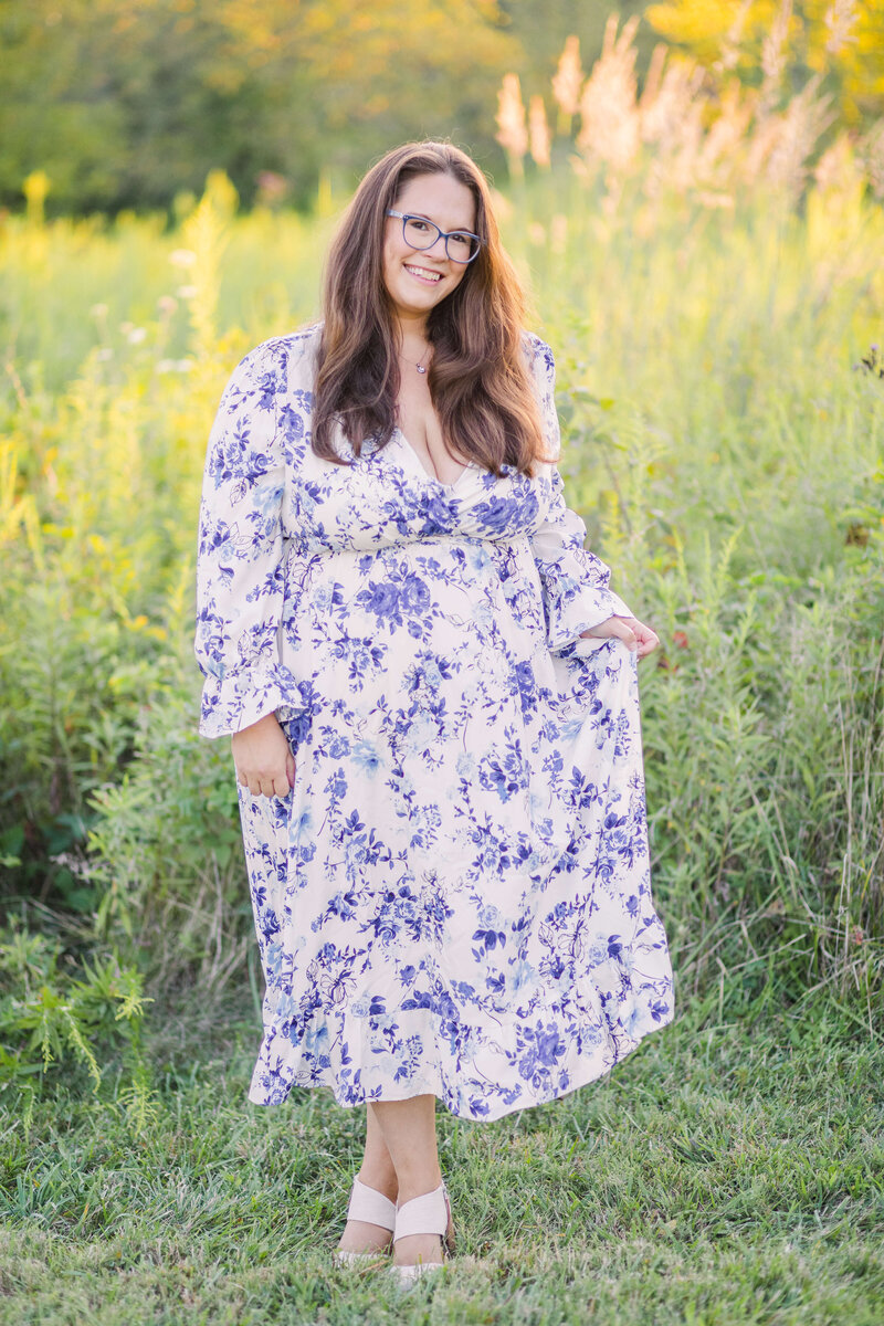 Ohio wedding photographer in a long, flowy dress in a meadow at french park smiling for a photograph