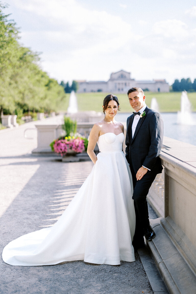 luxury wedding photo of bride and groom in front of vintage car at ritz carlton st louis missouri