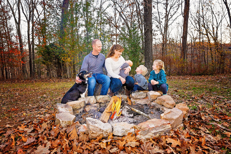 family and dog around fire pit