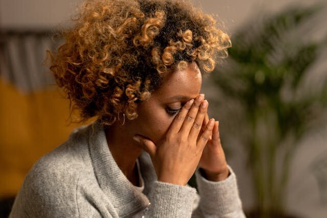 woman covering her eyes