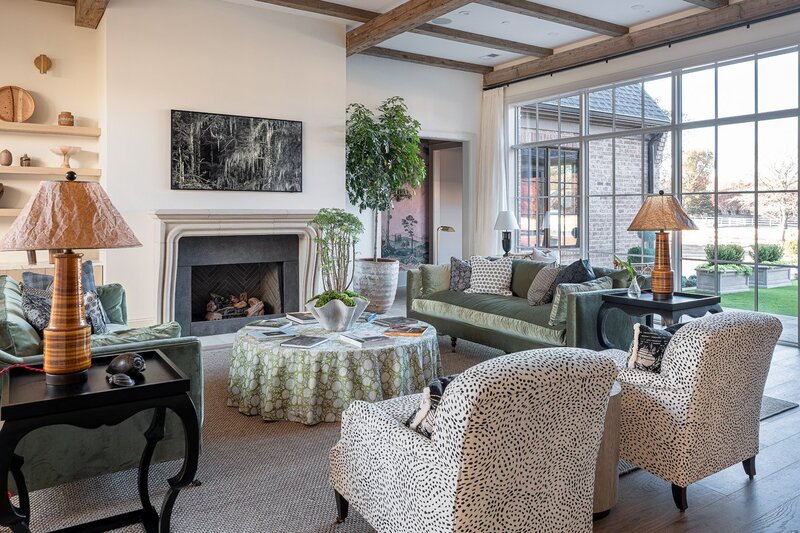 Interior design living room with layered textures and framed art modern traditional bespoke design  melds modern and traditional design beautifully. Details include wide plank, white oak french oak floors, tumbled stone, an custom iron staircase and a cozy, playful living space for hosting and relaxing.