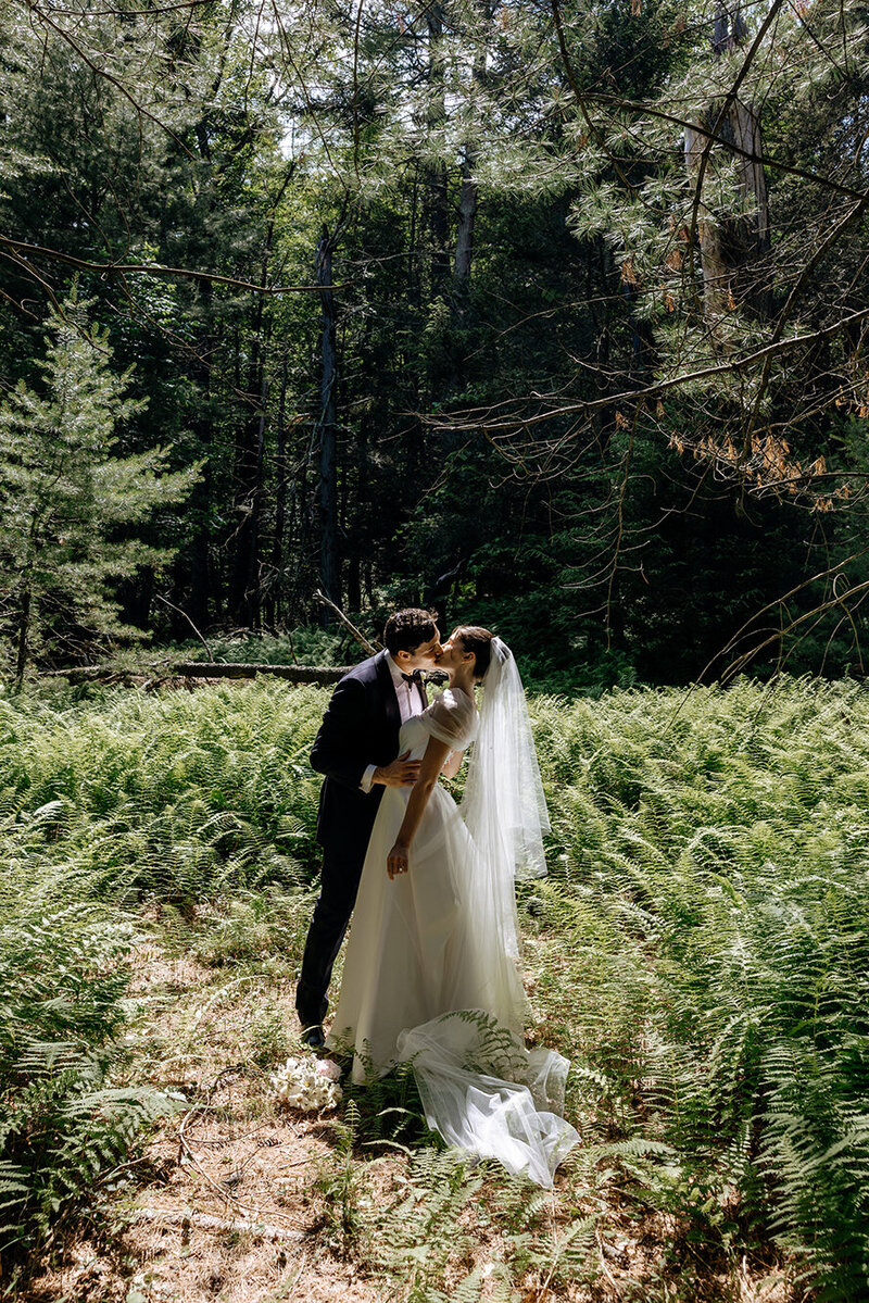 bride-groom-kissing-in-fern-forest-keli-photography-new-england-weddings-hudson-valley-weddings