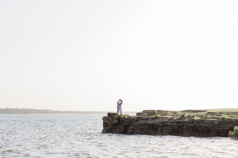 Couple standing on the cliffs edge at Rockledge Cliff for their engagement session.