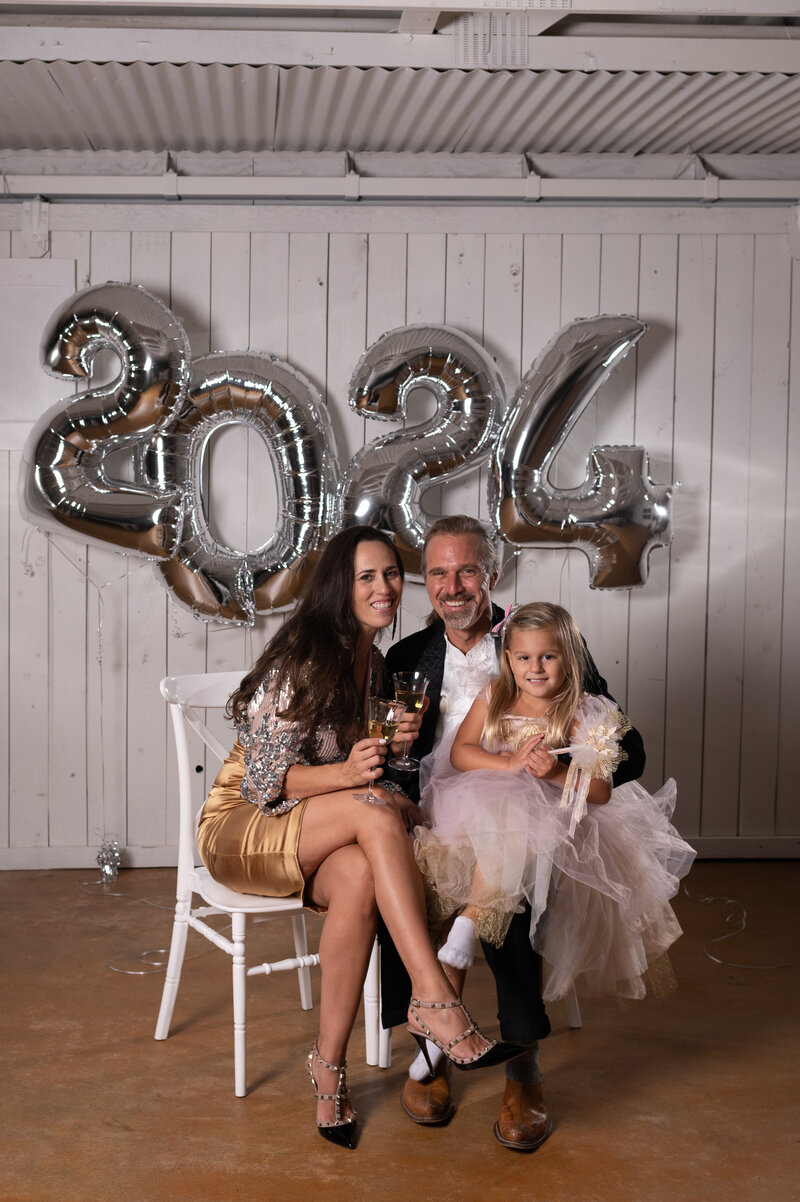 New Year's Portrait with a family of 3. Cheers! 2024! Photo taken by Dripping Springs Texas based Lydia Teague Photography.