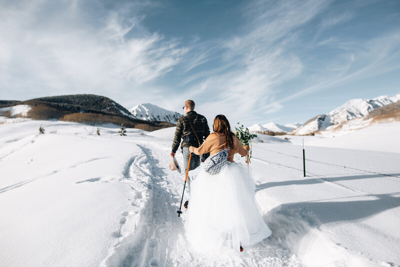 Couple snowshoes to their ceremony location in Crested Butte, Colorado.