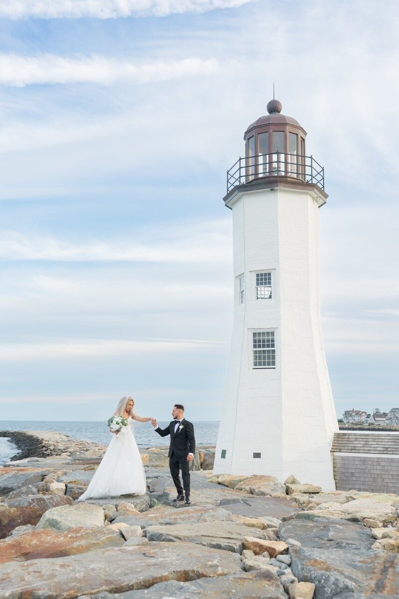 New England Wedding and Elopement Photographer Scituate lighthouse couple portraits barker house scituate, massachusetts, holding hands with a lighthouse background 