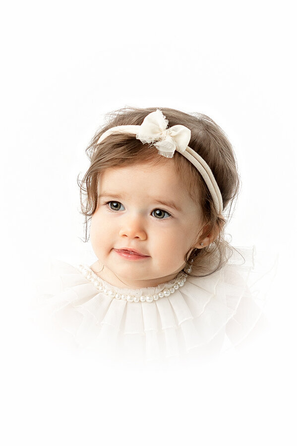 Heirloom portrait of baby girl in all white studio in fresno, ca