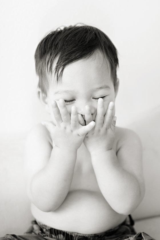 Black and white portrait of a baby boy laughing