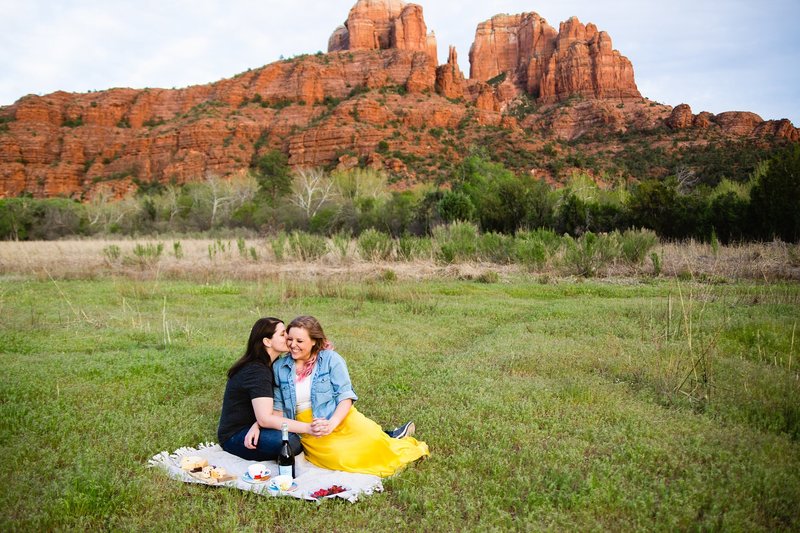 LGBT couple having a picnic during their Sedona engagement session by PMA Photography.