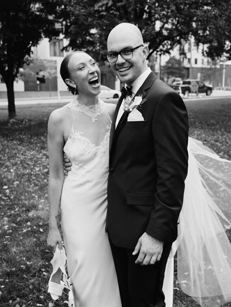 photo by tom thornton photography of happy minnesota wedding bride and groom smiling in black and white image