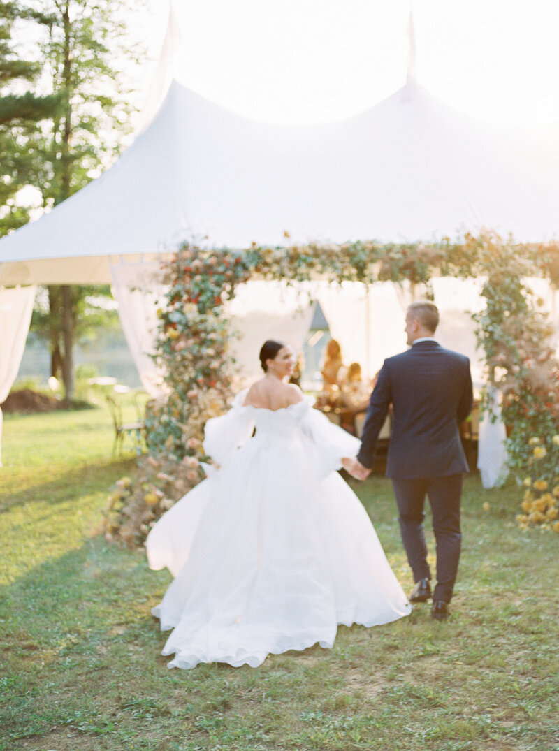 wedding couple holding hands and walking