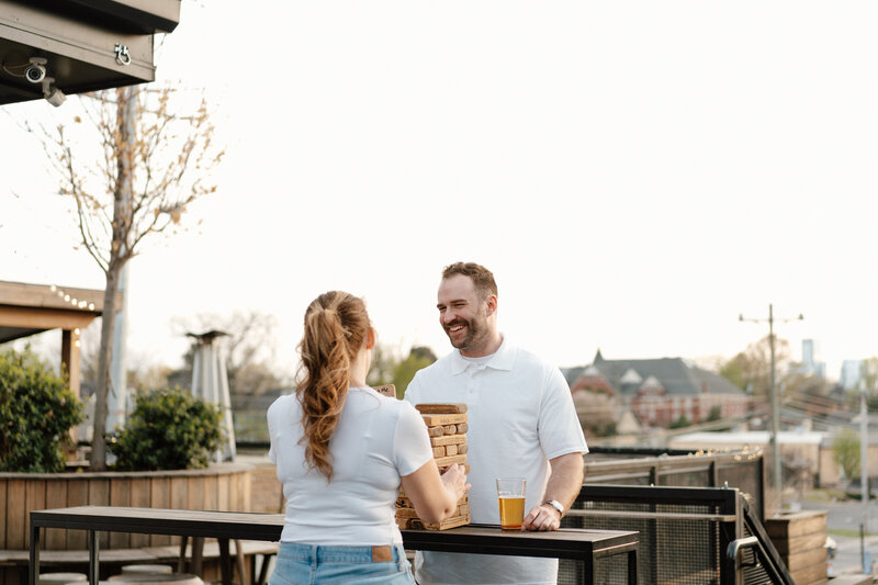 couple laughing playing games at a bar