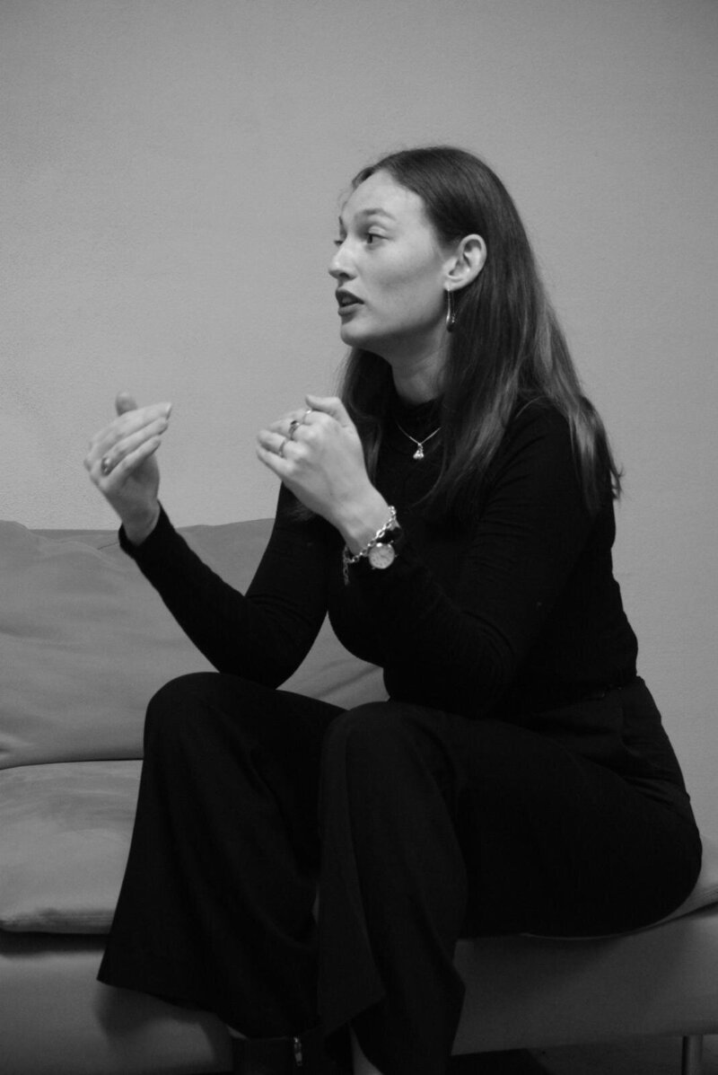 Cora Demary speaking in a group setting
