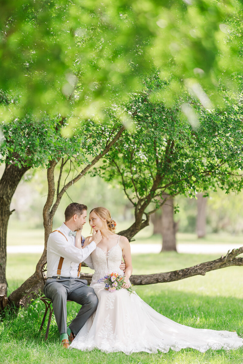 Bride-and-groom-sitting-looking-at-each-other