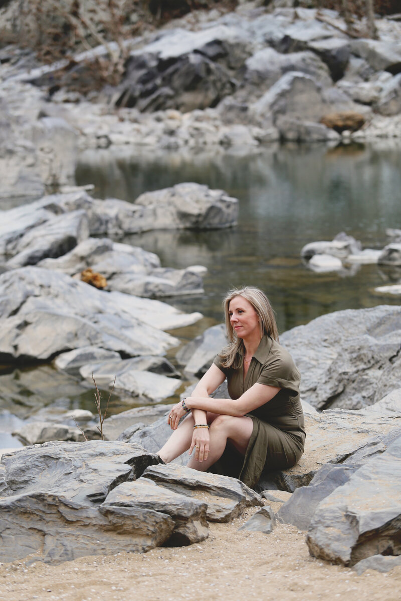 Woman holding coffee and looking out at the mountains