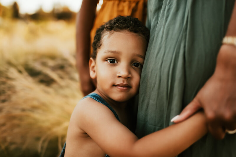 son holding tightly to his mother.